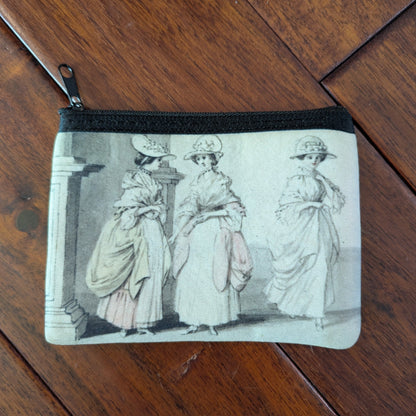Small unsaturated zipper pouch printed with 3 women from the 18th century with large dresses and bergere flat hats. Virgil's Fine Goods
