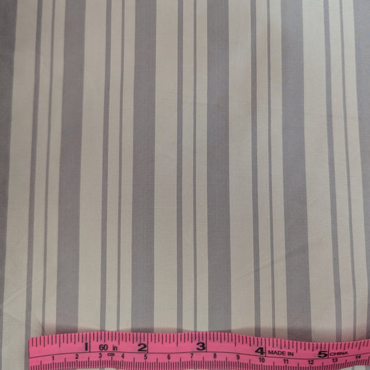 Off-white background with gray stripe woven into fabric. Yarn dyed silk. Photographed with a pink ruler to illustrate pattern scale.