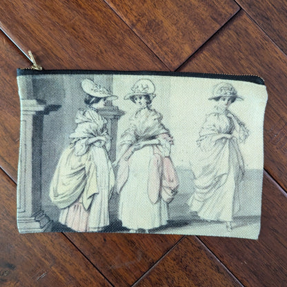 Large unsaturated zipper pouch printed with 3 women from the 18th century with large dresses and bergere flat hats. Virgil's Fine Goods