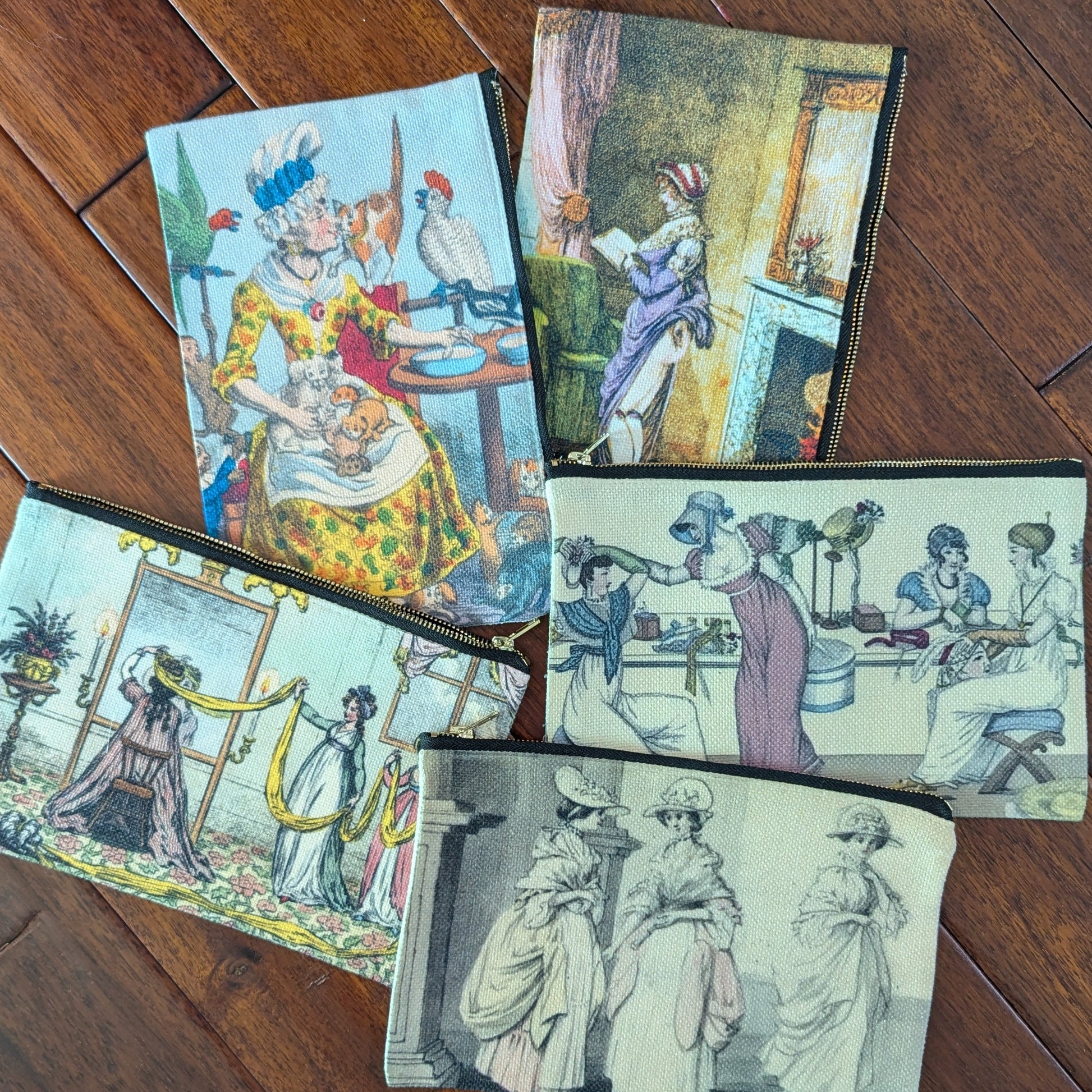 Colorful zipper pouches printed with historical prints from satirical papers from the 19th and 18th centuries. Virgil's Fine Goods