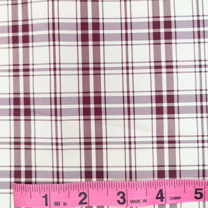 Off-white background with red plaid pattern woven into fabric. Yarn dyed silk. Photographed with a pink ruler to illustrate pattern scale.