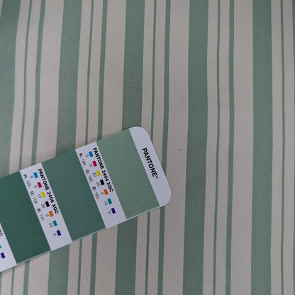 Off-white background with sage green stripe woven into fabric. Yarn dyed silk. Photographed with pantone chip for color reference and matching.