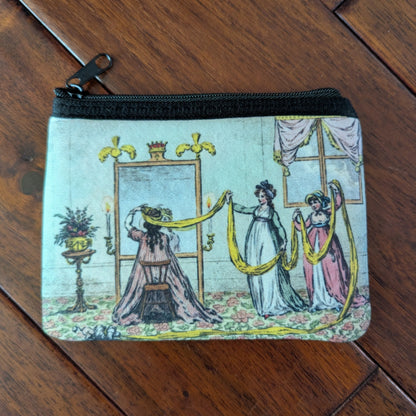 Small zipper pouch printed with 3 women with a long yellow scarf to help a woman sitting at a mirror with wrapping hair for turban. From the 19th century with bright dresses and aqua colored room with floral floor. Virgil's Fine Goods