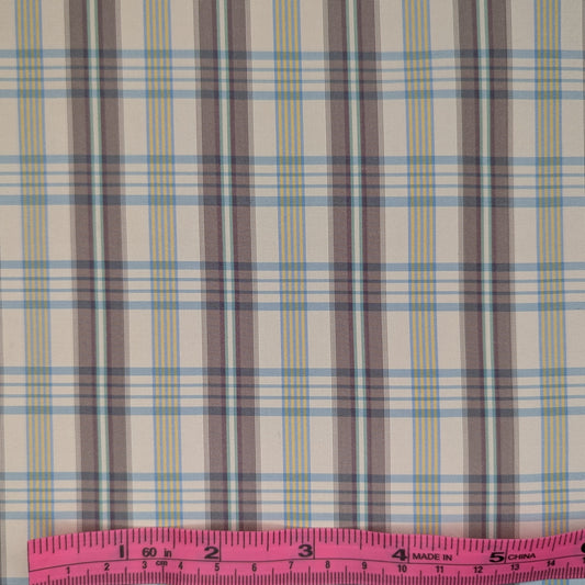 Off-white background with multicolored plaid pattern woven into fabric. Yarn dyed silk. Photographed with a pink ruler to illustrate pattern scale.